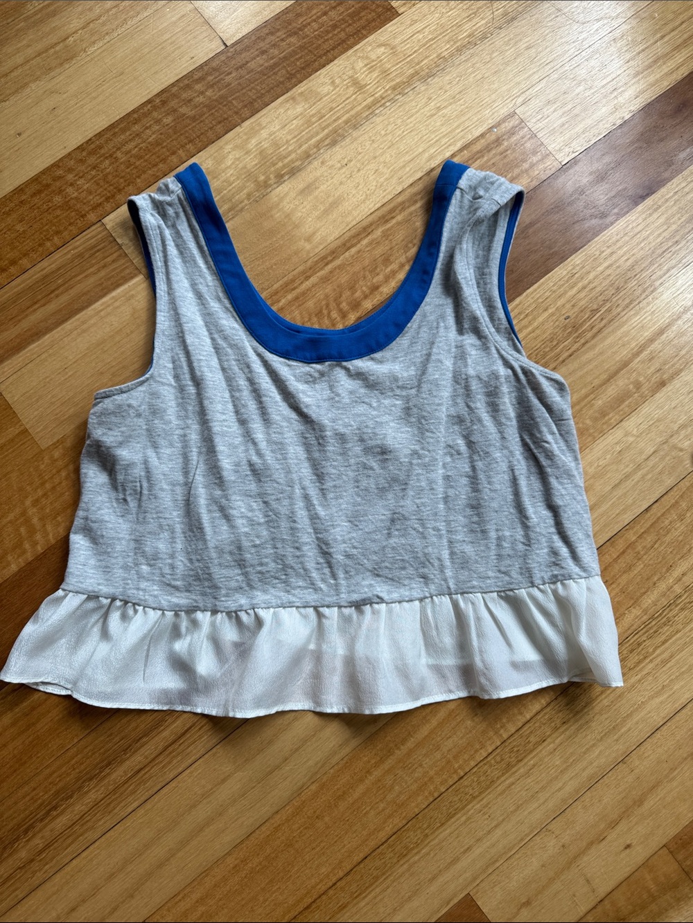 Sleeveless Gray Crop Top with Blue Trim and White Ruffle Hem